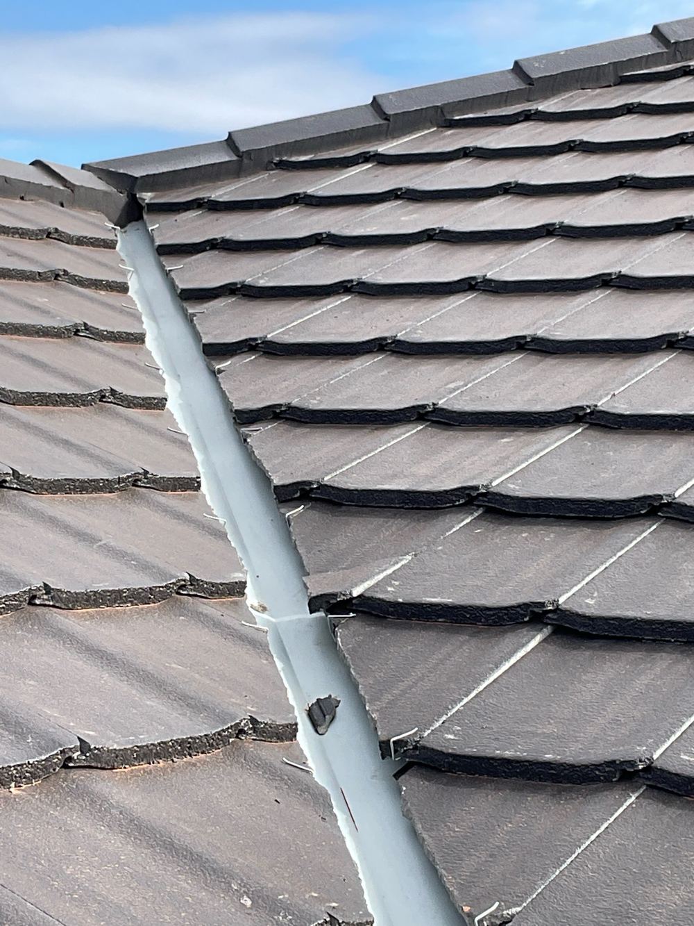 Cracked roof tile on a brand new roof that will let water through, found during a lock-up inspection in Strathtulloh