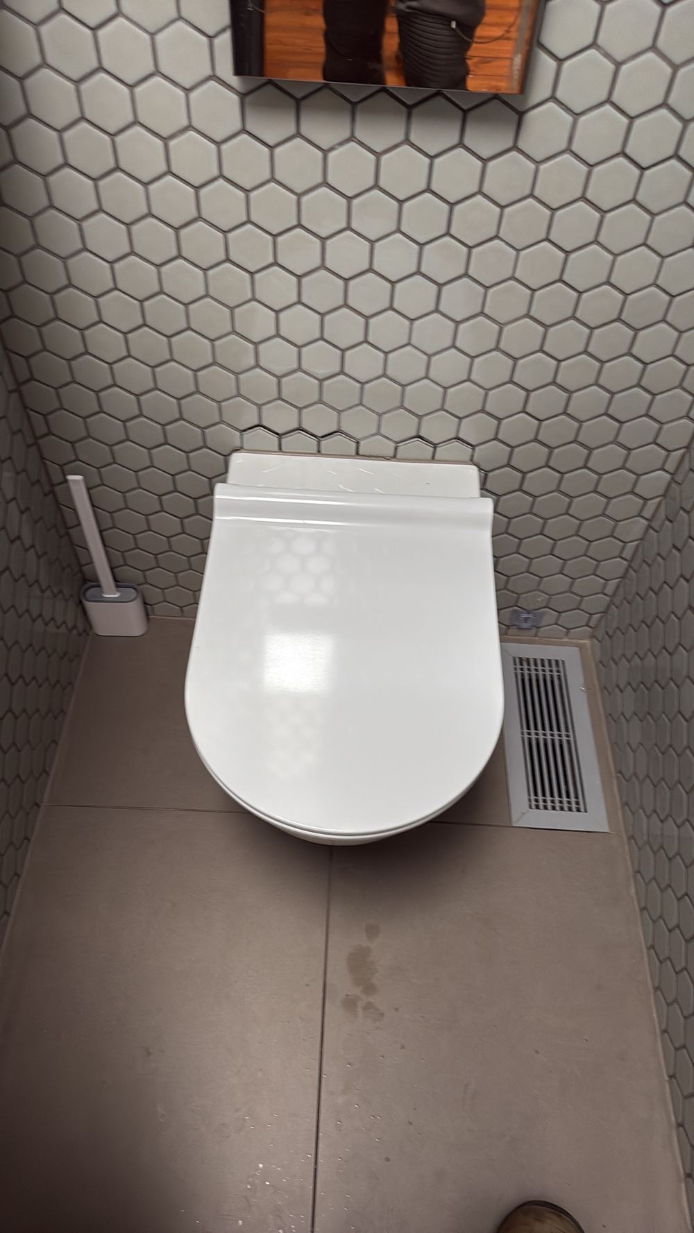 Toilet pan moving under light pressure and lifting floor tiles, found during a pre-purchase inspection in Hawthorn