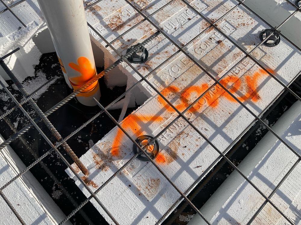 Reinforcement sitting too close to the concrete face, leaving thin cover against rust, found during a slab pre-pour inspection in Strathtulloh