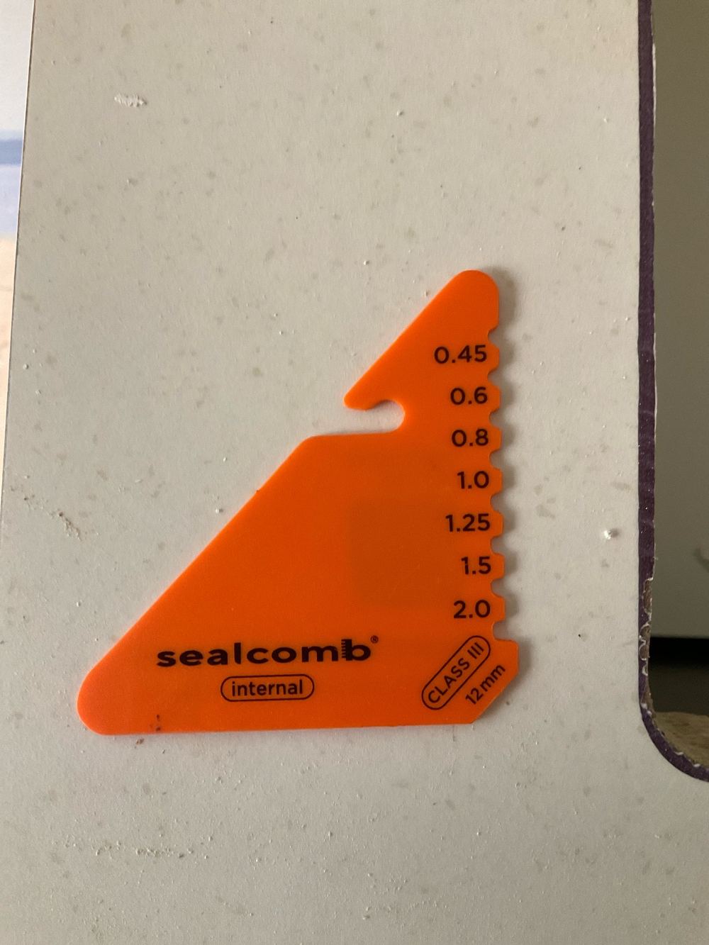 Bond breaker at the shower hob too thin to let the membrane flex, found during a waterproofing inspection in Strathtulloh